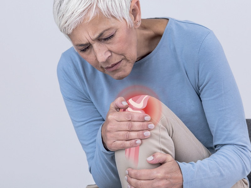 Physiotherapist giving knee therapy to a woman Physiotherapist giving knee therapy to a woman in clinic. Physical treatment concept